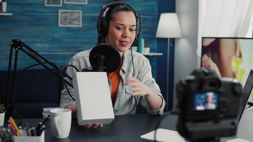 Woman Recording Video About a Box on Desk