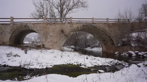 Byzantine architecture old bridge over river on a winter bacground with white snow in Albania