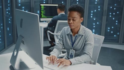 African American Young Female IT Administrator Cooperating in Office Multiethnic Professional Team