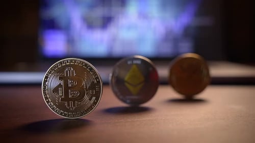 Various Cryptocurrency Coins Placed on a Table with a Vibrant Market Background Behind Them