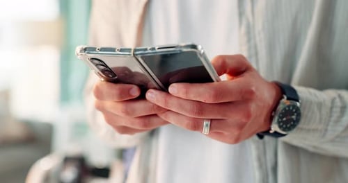 Close Up of Hands Holding a Foldable Phone