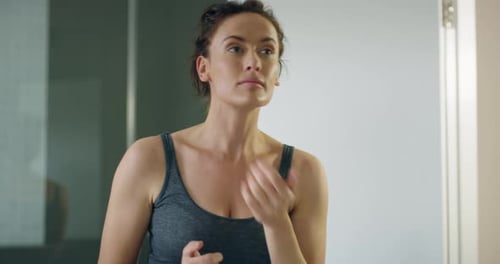 Woman Applies Moisturizer to Her Face