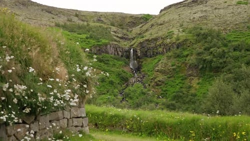 Idyllic Iceland: Traditional Turf House and Waterfall Scenery
