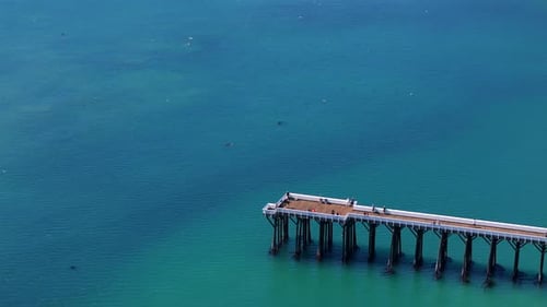 Marvelous Scenic Aerial View of a Coastal Pier Over Stunning Turquoise Waters in Natures Beauty