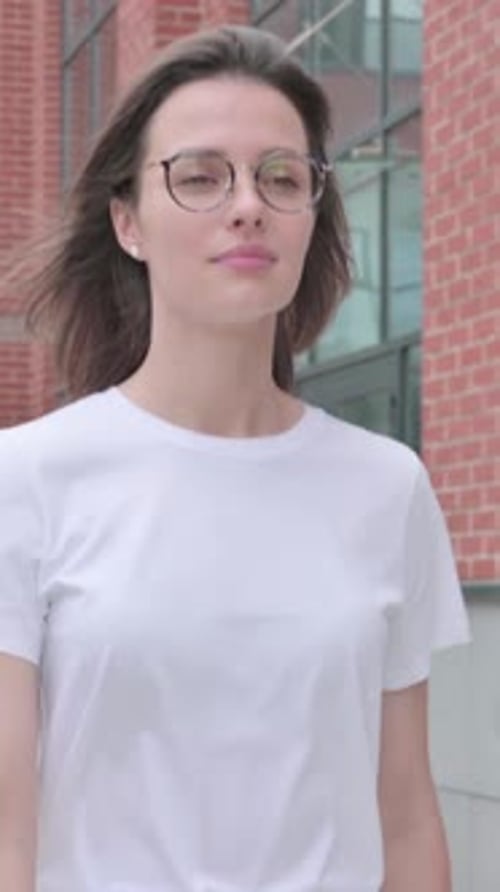 Close up of Young Woman Walking on Street, Front Pose, vertical video