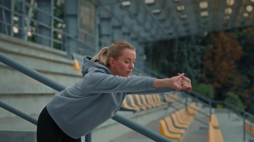 Woman Stretching Before Workout at Urban Stadium