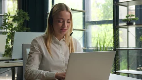 Caucasian Businesswoman Girl Operator in Headset Working Customer Helpline Service in Call Center