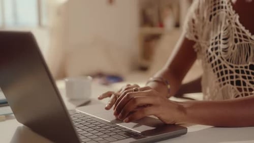 Hands of Girl Using Laptop and Making Notes at Desk