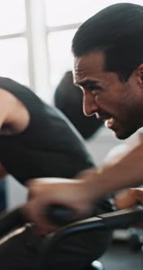 Exercise bike, fitness and men in gym, training and challenge with motivation, sweating and power