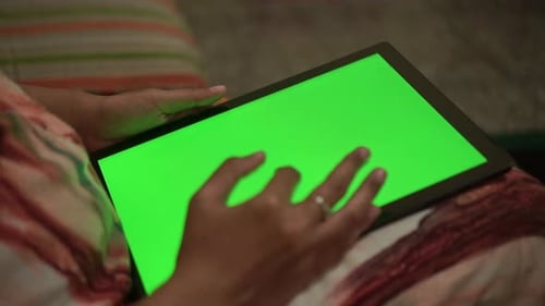 Hand interacting with tablet green screen. Digital device, touchscreen interface