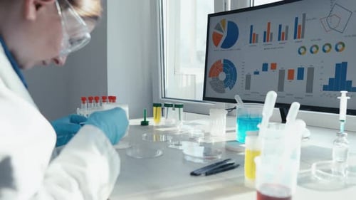 Scientist Works in Brightly Lit Laboratory