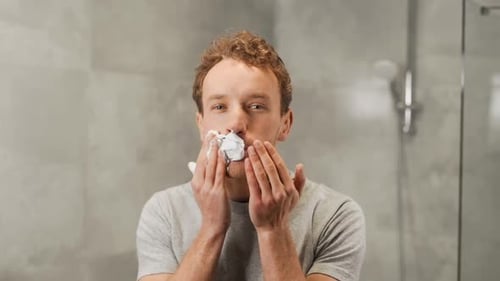 Young Man Applying Shaving Cream in Bathroom