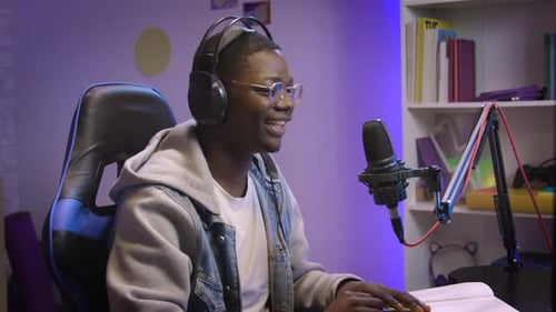 Young Adult Speaking Into Microphone Wearing Headphones