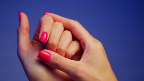 Woman's Hands with Bright Pink Nail Polish Interlocked