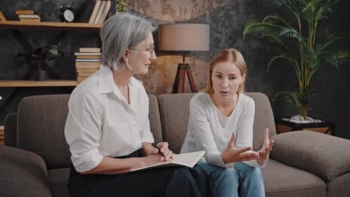 Woman Discusses Problems with Therapist on Couch
