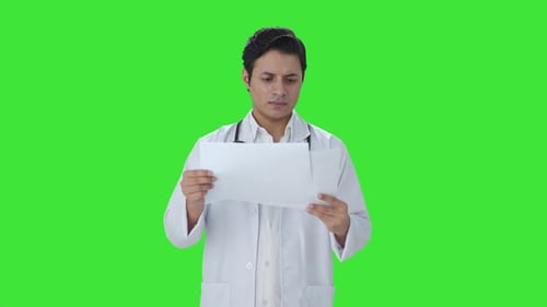 Indian doctor checking medical reports Green screen