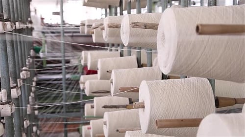 Spools of Yarn Revolving in Factory Textile Mill