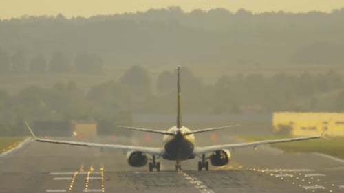 Airplane Taking off from Airport Runway at Sunrise