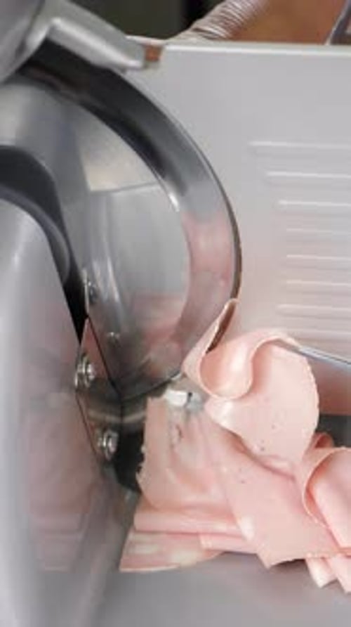 Food Industry and Gastronomy Chef Using Cutting Machine for Cutting Meat in Restaurant Kitchen