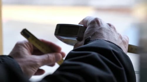 Hands Hold Yellow Tape Measure for Measurement