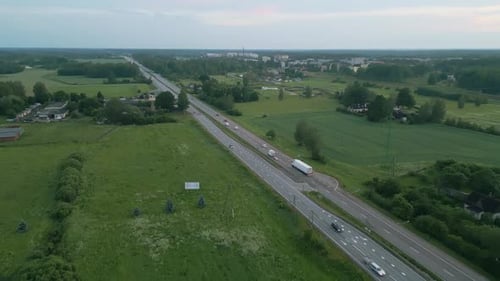 Capture the Beauty of a Lush Green Countryside with a Major Highway Running Through It From an