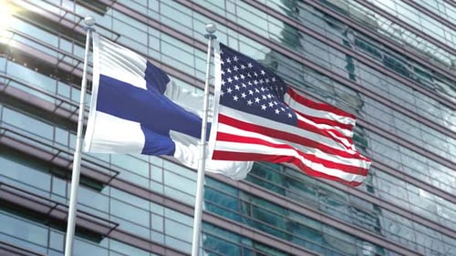 Finland and USA Flags Waving on Corporate Building Background