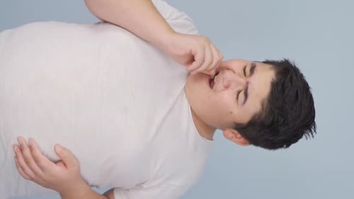 Young Adult Removing Food from Teeth, Close Up
