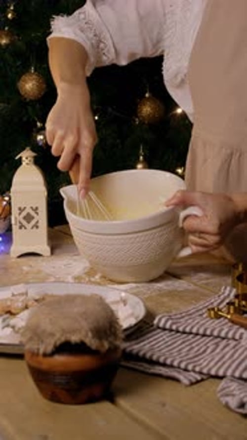 A Young Woman is Mixing Dough Ingredients with a Whisk Surrounded By a Festive New Year and