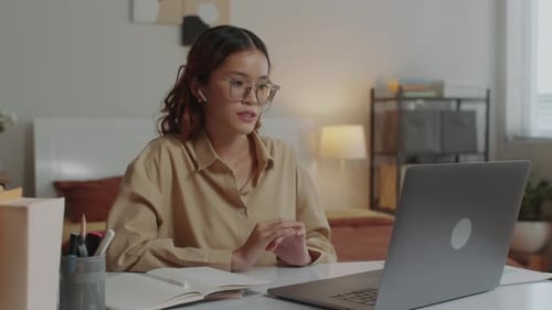 Young Woman on Video Call at Desk