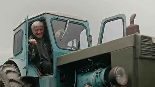 Smiling Man on Tractor in Rural Setting