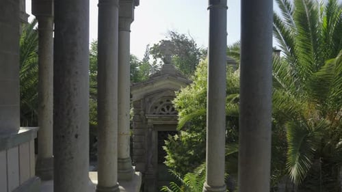 View Through Stone Pillars of a Historic Mausoleum in a Cemetery