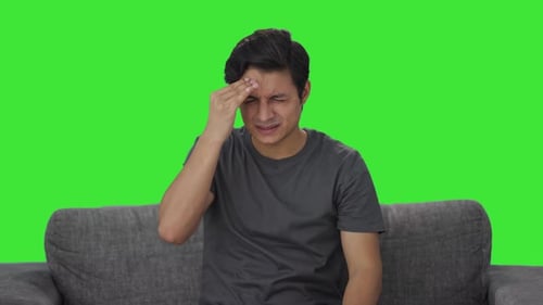 Sick Indian man suffering from headache Green screen