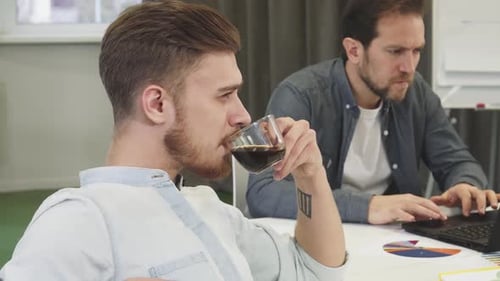 Men Working Together in Office Environment