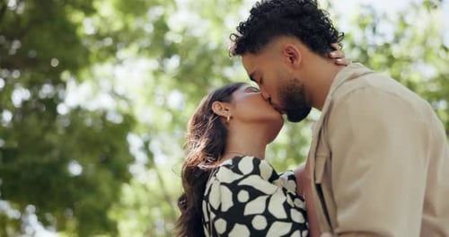 Care, love and kiss with couple in park for embrace, loyalty and romance together