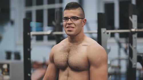 Muscular Man Posing in the Gym