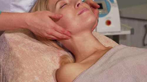 Radiant Woman Indulging in a Rejuvenating Facial Spa Treatment