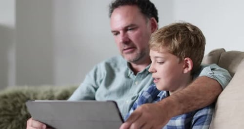 Close-up Father and Son looking at a digital tablet