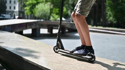 Boy jumping on a skateboard in a sport park, slow motion