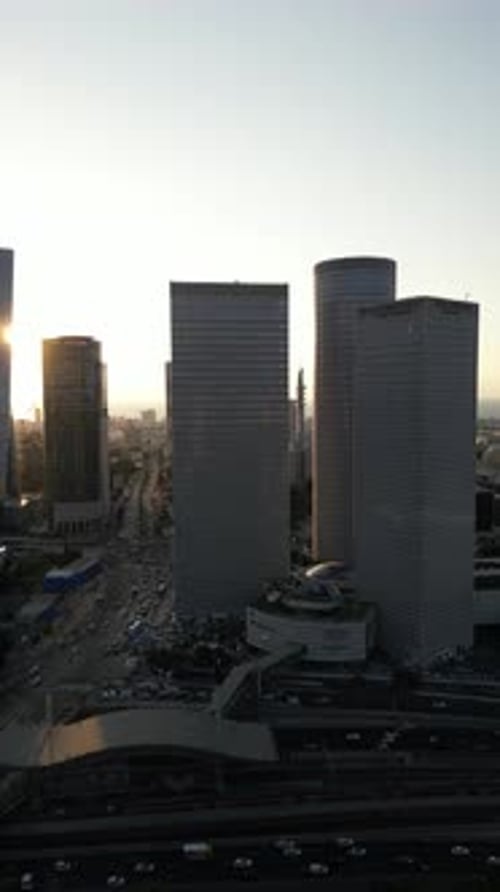 Aerial Shot Of Cityscape By Sea Against Sky At Sunset, Drone Descending Forward Over City - Tel Aviv