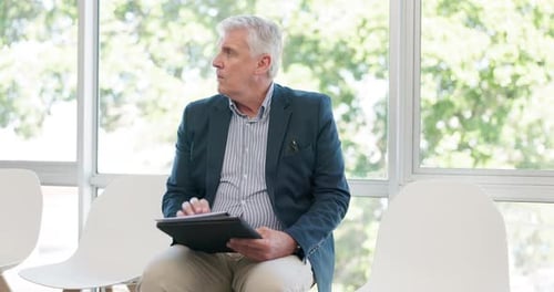 Interview, office and senior businessman waiting with a file for a corporate onboarding or meeting