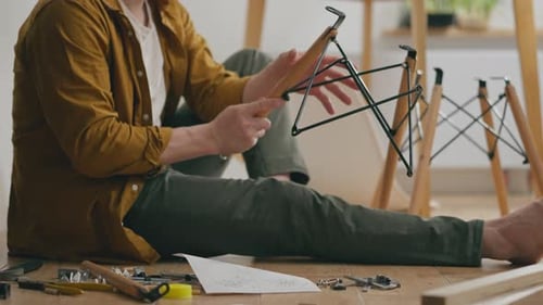 Active White Guy Intensely Assembles Quickly Prefabricated Furniture With His Own Hands In A Bright