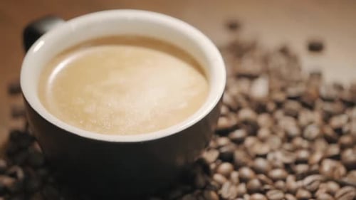 Close up of Coffee Cup with Coffee Beans