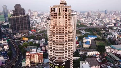 Drone shots of the famous Sathorn Unique Tower (Ghost Tower) in Bangkok, Thailand