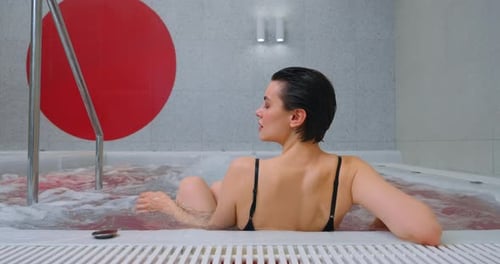 Relaxation And Recovery Body And Mind Health Young Woman Lying In Jacuzzi In Modern SPA