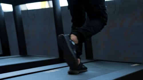 Male training in sport club. Close up of athletic feet running on treadmill in fitness gym