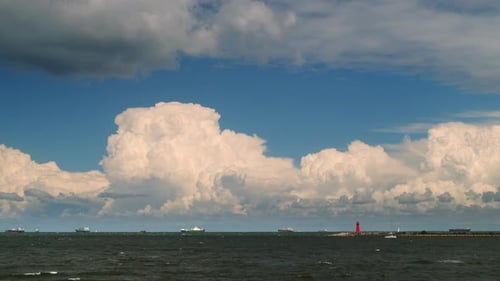 Timelapse Movement of Cumulus Rain Clouds Over the Sea with Ships