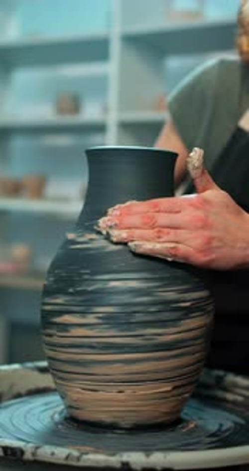 Potter Shaping Clay Vase on Spinning Wheel