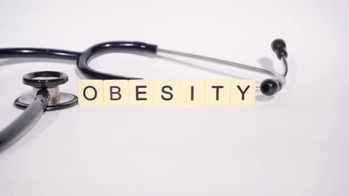 Stethoscope and Obesity Blocks on White Background