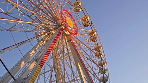 Ferris Wheel At Sunset Light In Amusement Park