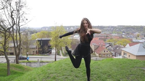Dancer performing a contemporary routine in a park